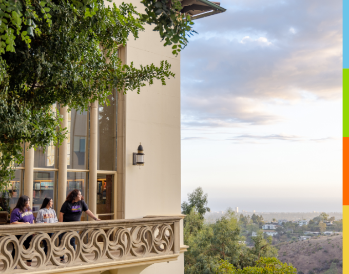 Students on a balcony looking at campus.